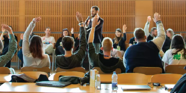 Students raising hands during a workshop